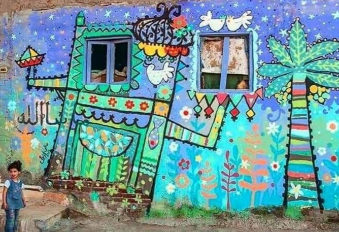 إحدي الجداريات التي تم تنفيذها في أحد الدورات السابقة للملتقي.jpg