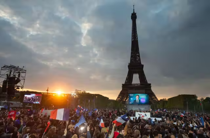 Supporters of Macron celebrate at the Champ de Mars in Paris, 24 April 2022 (EPA).png