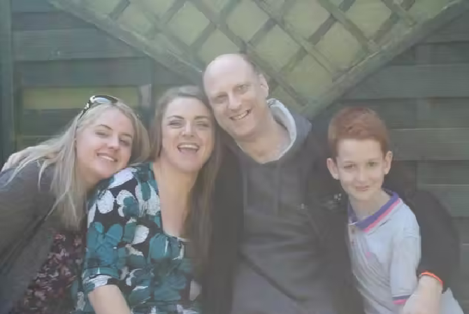Abbi Smith, who was diagnosed with autism and learning difficulties early in her life, with her family (Handout).png