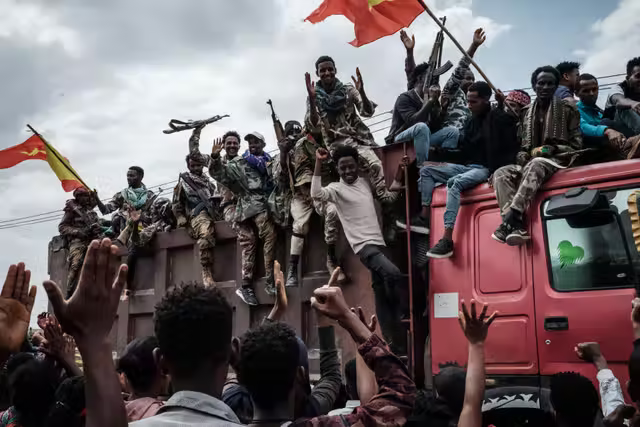 Tigray People’s Liberation Front (TPLF) fighters react to locals as they arrive in Mekele, the capital of Tigray region, in June 2021.png