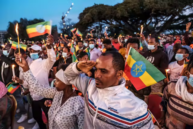 A man makes a salute during a memorial service for the victims of the Tigray conflict organised by the city administration, in Addis Ababa, in November 2021.png