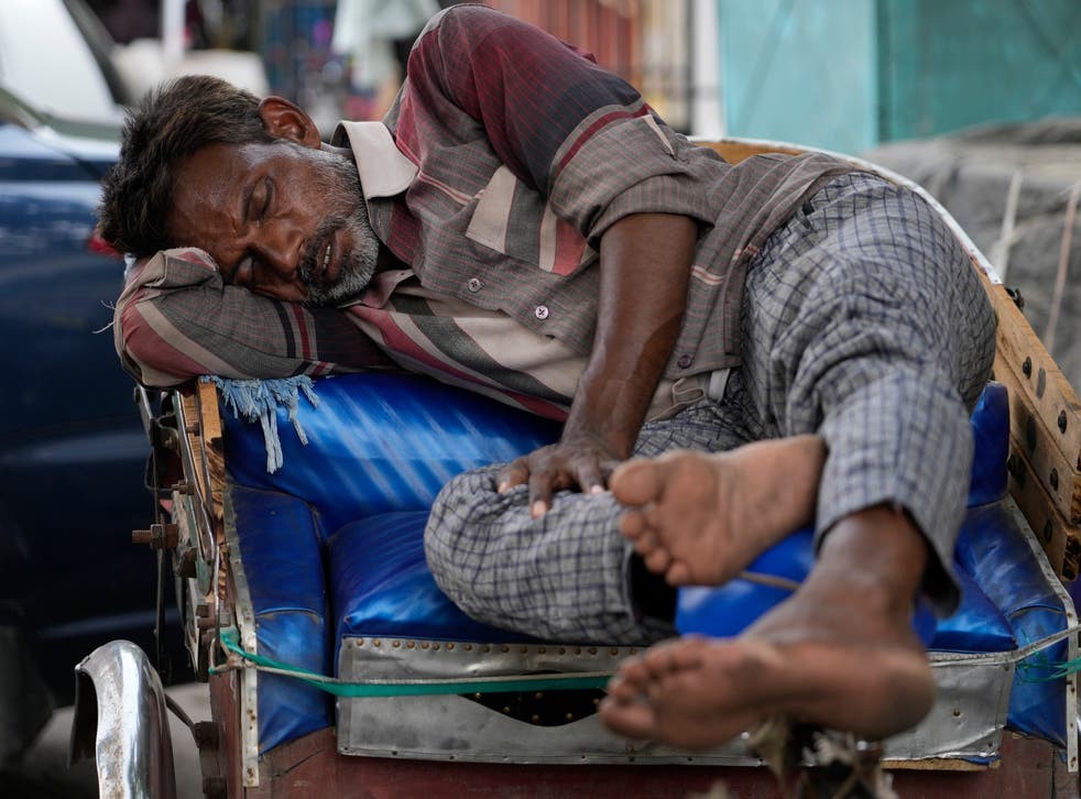 A man sleeps on his rickshaw_أب.jpg