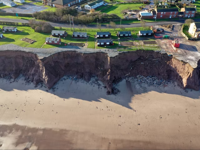 Holiday chalets abandoned due to coastal erosion wait to be demolished or taken by the sea in the village of Withernsea in the East Riding of Yorkshire in 2020.png