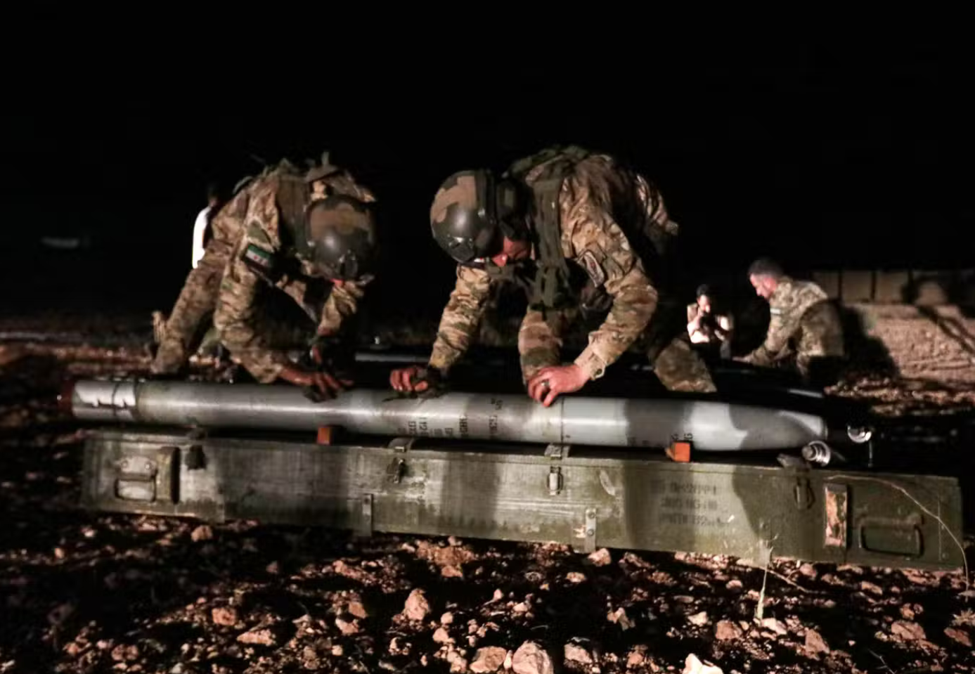  مقاتلون سوريون مدعومون من تركيا يستعدون لتلقيم صاروخ غراد البعيد المدى تمهيداً لإطلاقه