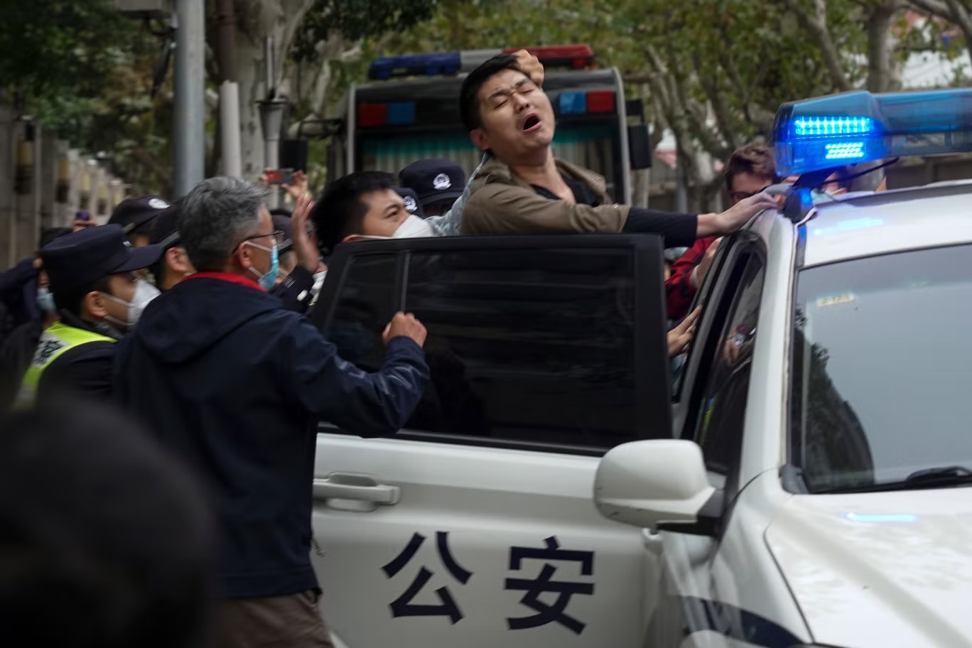 القبض على متظاهر خلال احتجاج في شوارع شنغهاي يوم الأحد (أ ب)