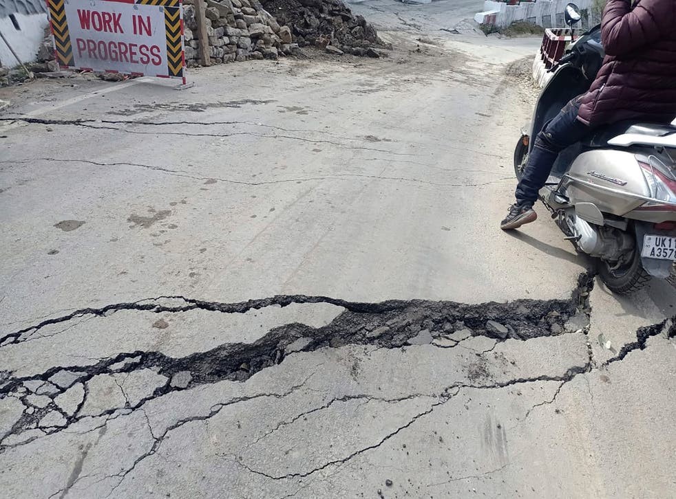 A motorist navigates his way through a crack on a road in Joshimath, India-ap.jpg