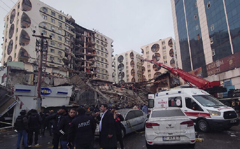Rescue workers and medical teams try to reach trapped residents in a collapsed building following and earthquake in Diyarbakir AP.jpg