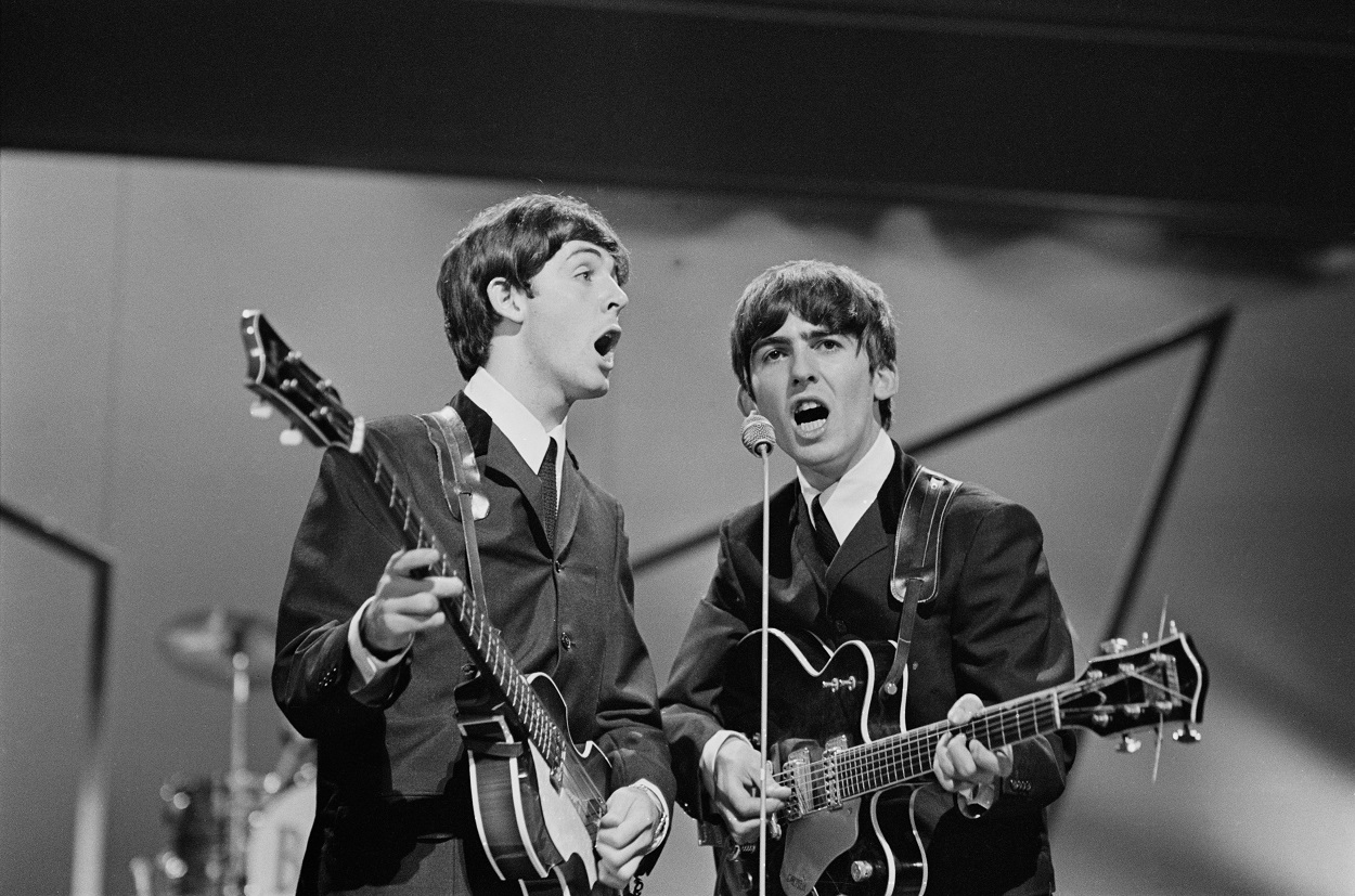 Paul McCartney and George Harrison on stage at the London Palladium on 13 October 1963_getty.jpg