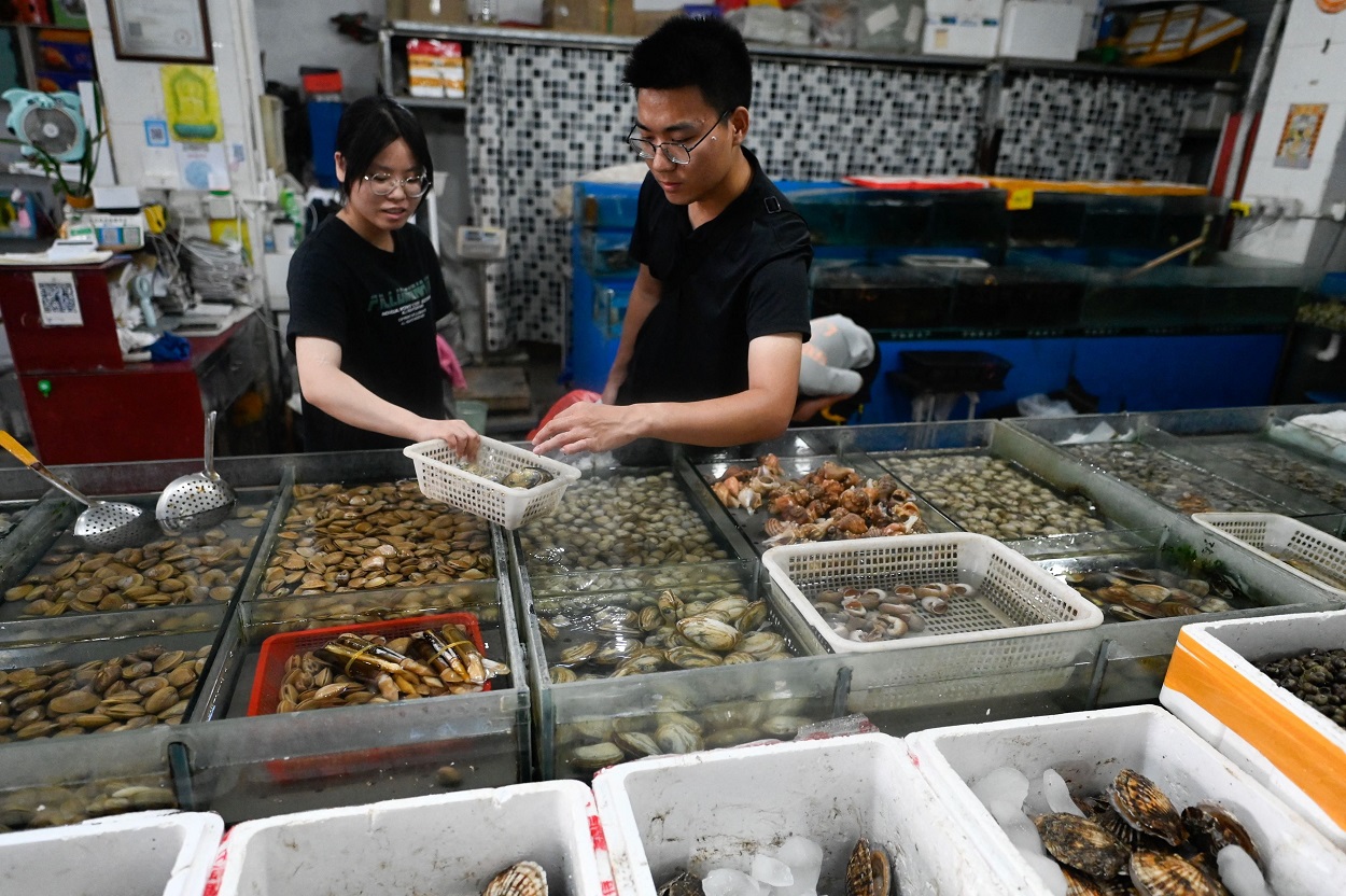 Stall workers at the Jingshen seafood market in Beijing_getty.jpg