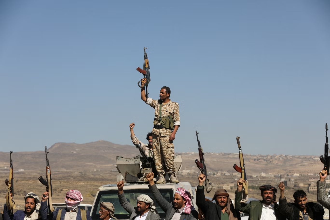 مقاتلون حوثيون ومؤيدون قبليون يرفعون أسلحتهم النارية خلال احتجاج على الضربات الأخيرة التي قادتها الولايات المتحدة على أهداف حوثية (رويترز)