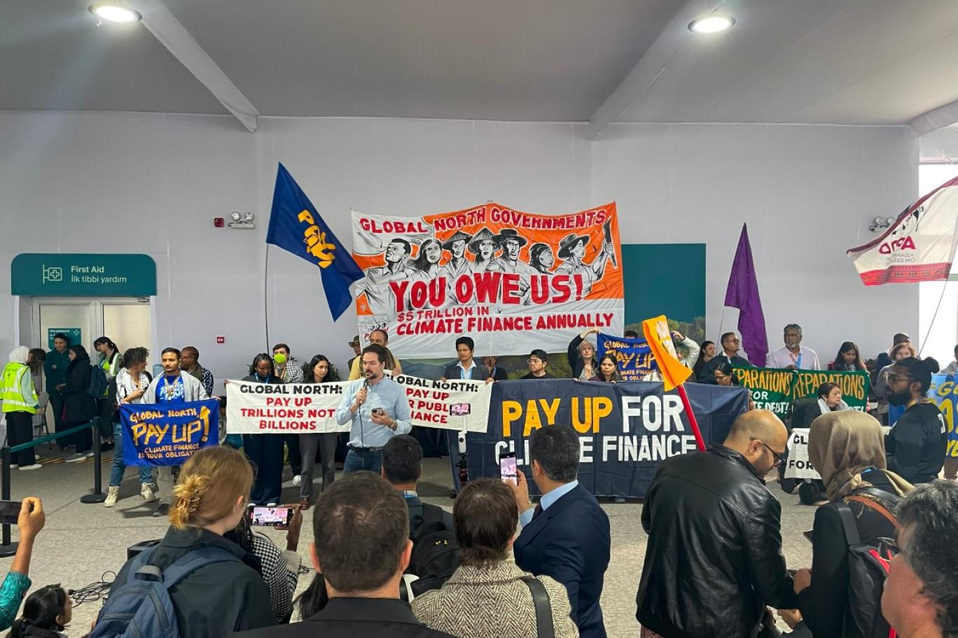 نشطاء يحملون لافتات لمطالبة الدول الغنية بمساعدة الدول النامية على معالجة ظاهرة الاحتباس الحراري (أ ف ب).jpg