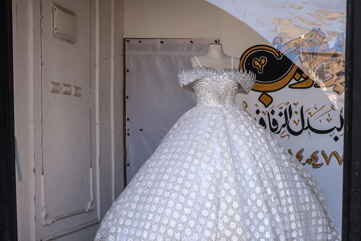 AFP__20260616__B78W8G3__v5__MidRes__PalestinianIsraelConflictDressmakerWedding.jpg