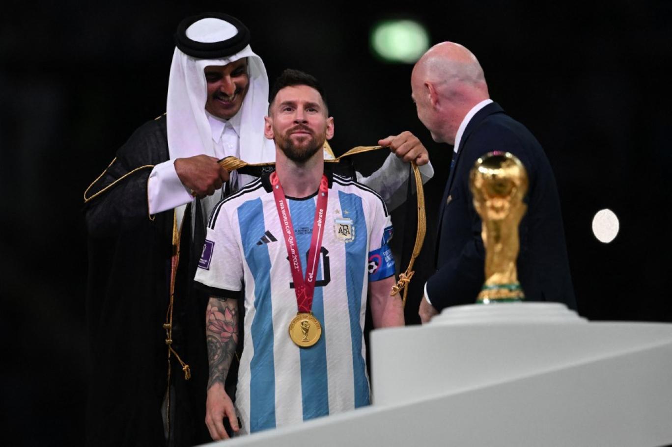 ميسي يرتدي البشت العربي بعد فوز الأرجنتين بلقب كأس العالم 2022   (أ ف ب)